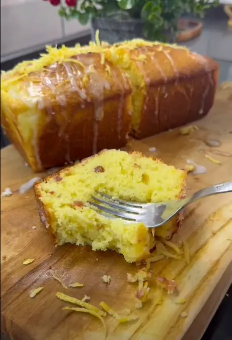 Rich lemon loaf cake baking in loaf pan inside oven