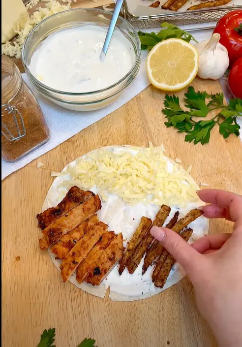 Marinated chicken gyros cooking in a skillet with Mediterranean spices