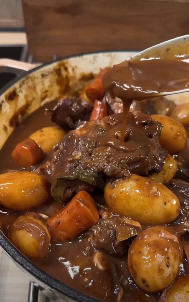 Fall apart braised beef served with fresh parsley garnish