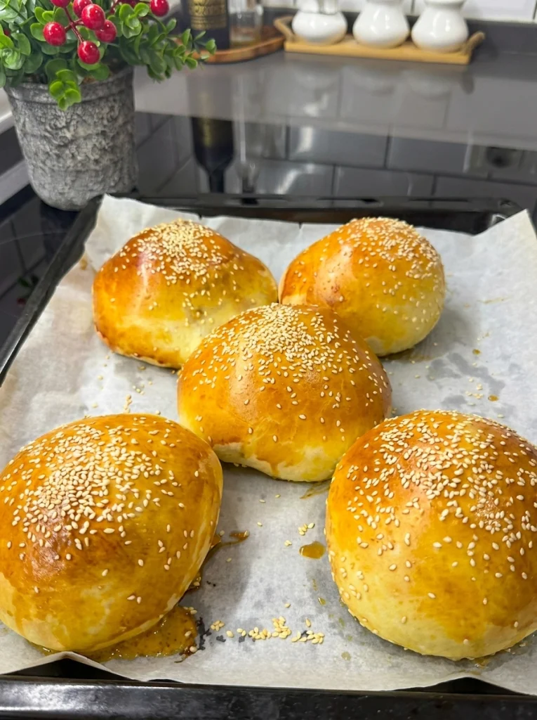 Freshly baked stuffed cheeseburger buns with a golden brown crust