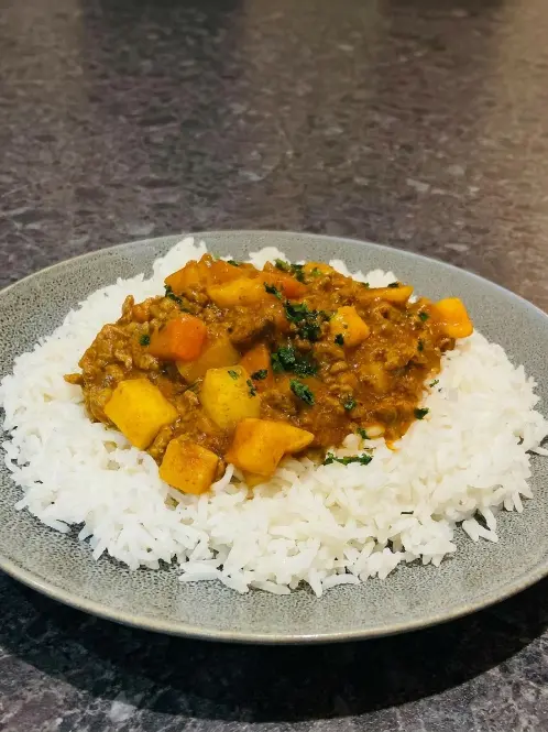 Beef mince curry with vegetables served over fluffy white rice