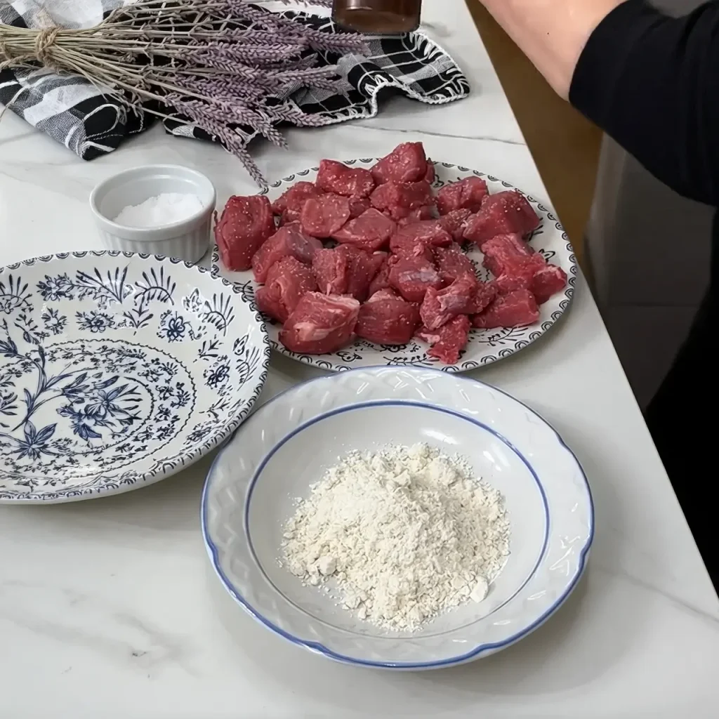 Browning beef pieces in a pot for beef stew with potatoes