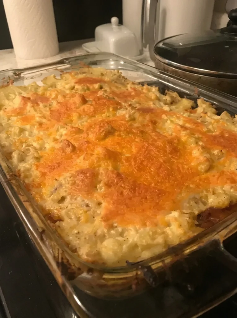 Slice of English cottage pie served hot with beef and creamy mashed potato layers