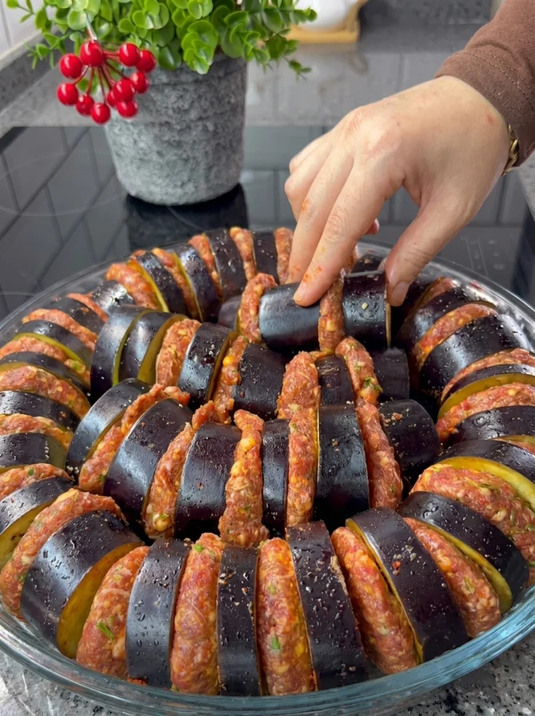 Eggplant slices soaking in salted water before baking