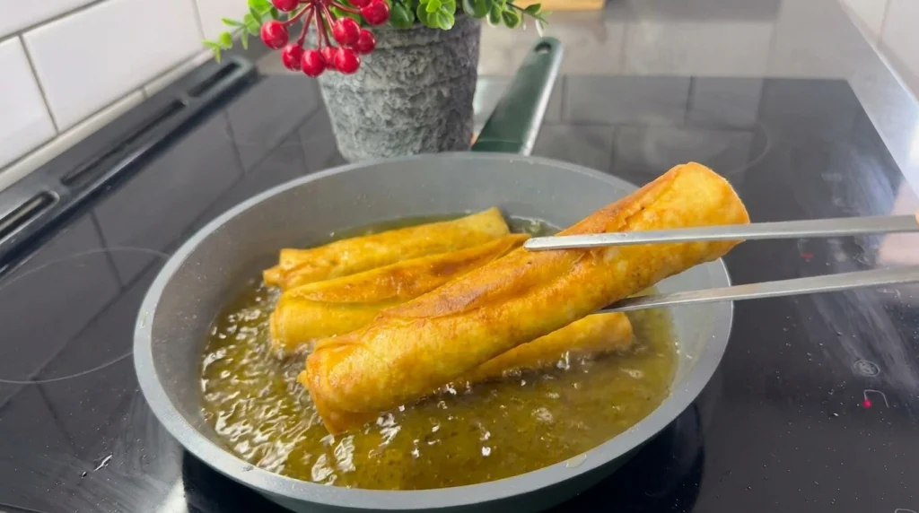 Savory stuffed pancakes frying in hot oil until golden brown