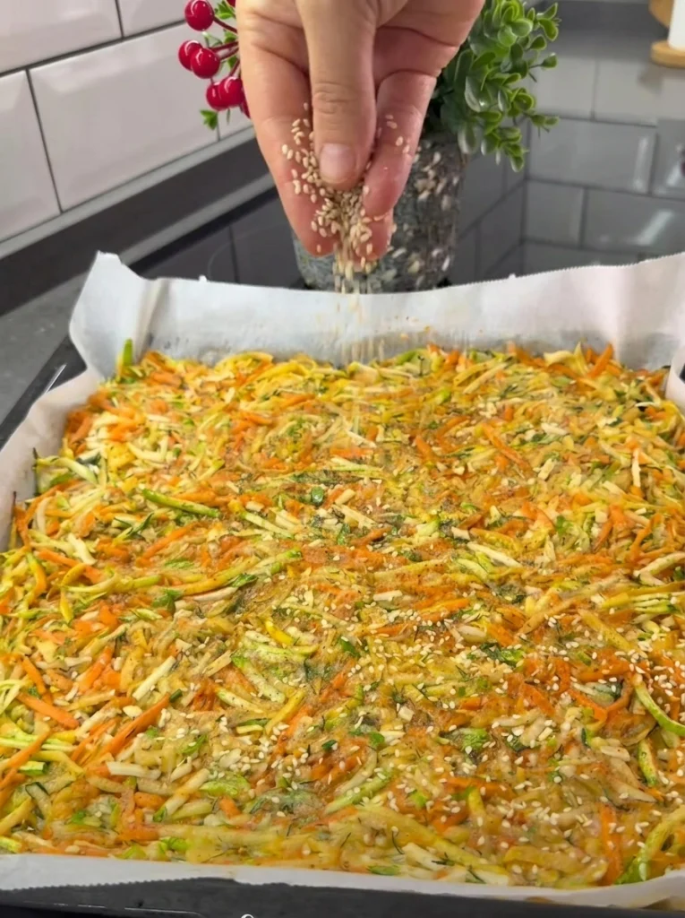 Vegetable lavash topped with sesame seeds before baking
