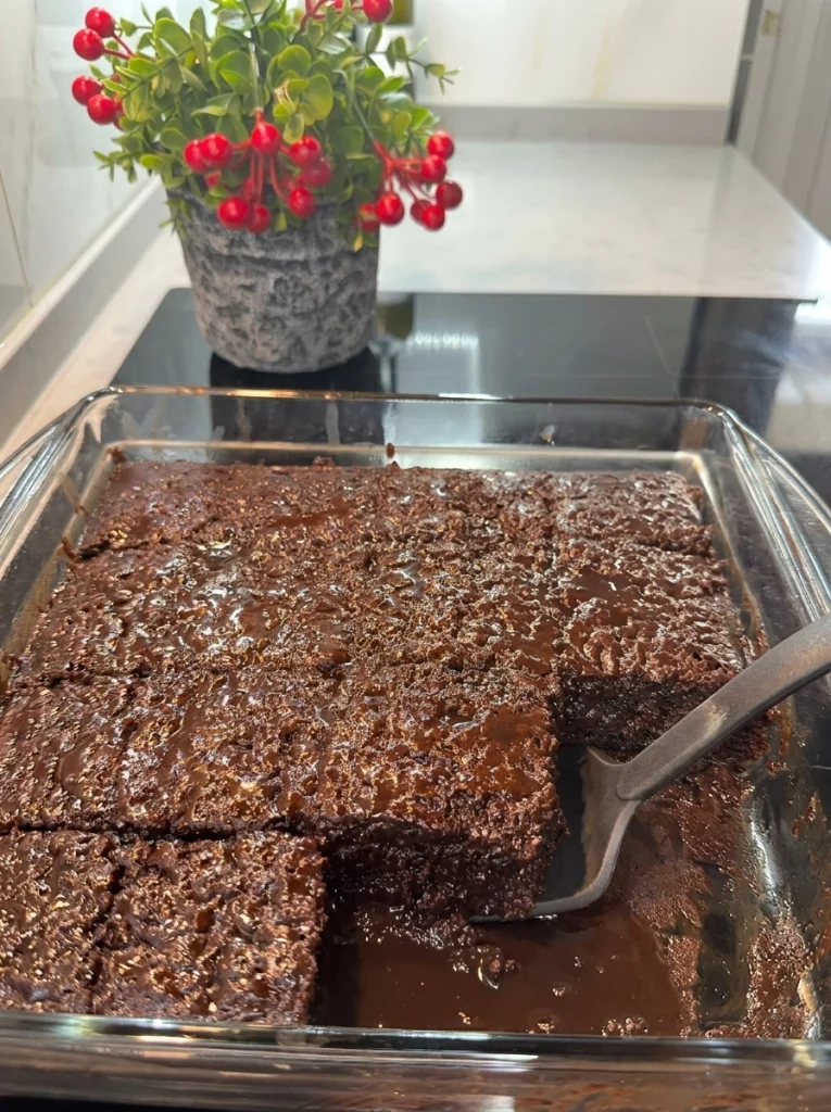 Close-up of a moist chocolate cake slice with chocolate sauce dripping