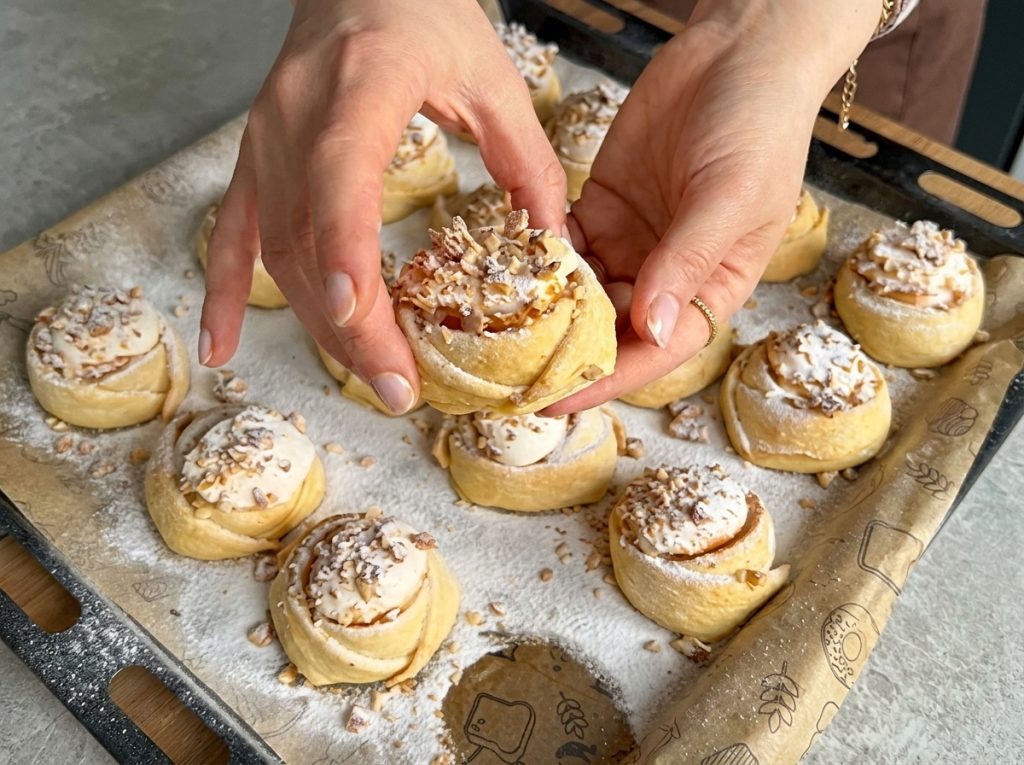 Pink Cookies with walnut meringue filling dusted with powdered sugar