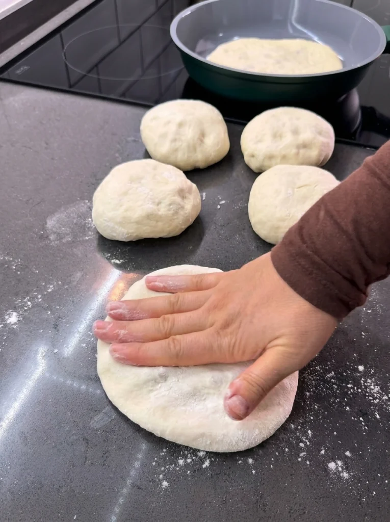 Pita dough stuffed with minced meat and grated cheddar cheese
