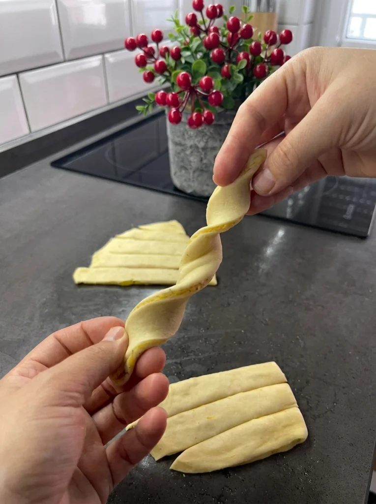 Homemade samosa dough being rolled out with rolling pin on floured surface for crispy potato samosa recipe