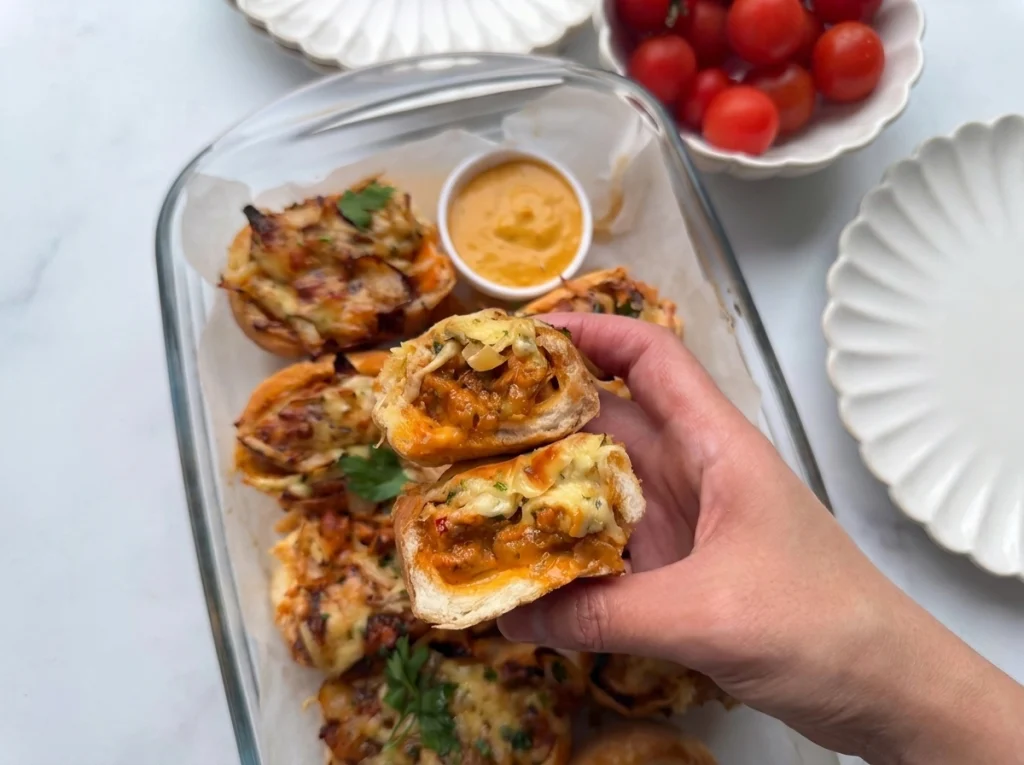 Spicy chicken cheese and onion sandwiches topped with melted cheese and caramelized onions