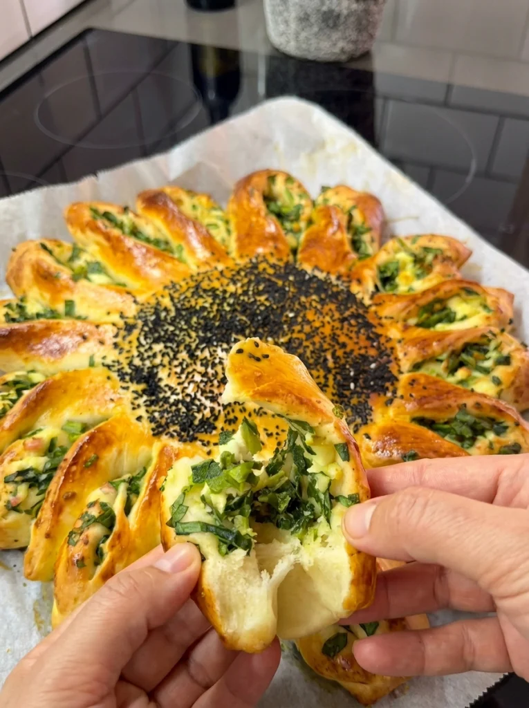 Brushing egg yolk on Spinach Sun Bun for golden finish
