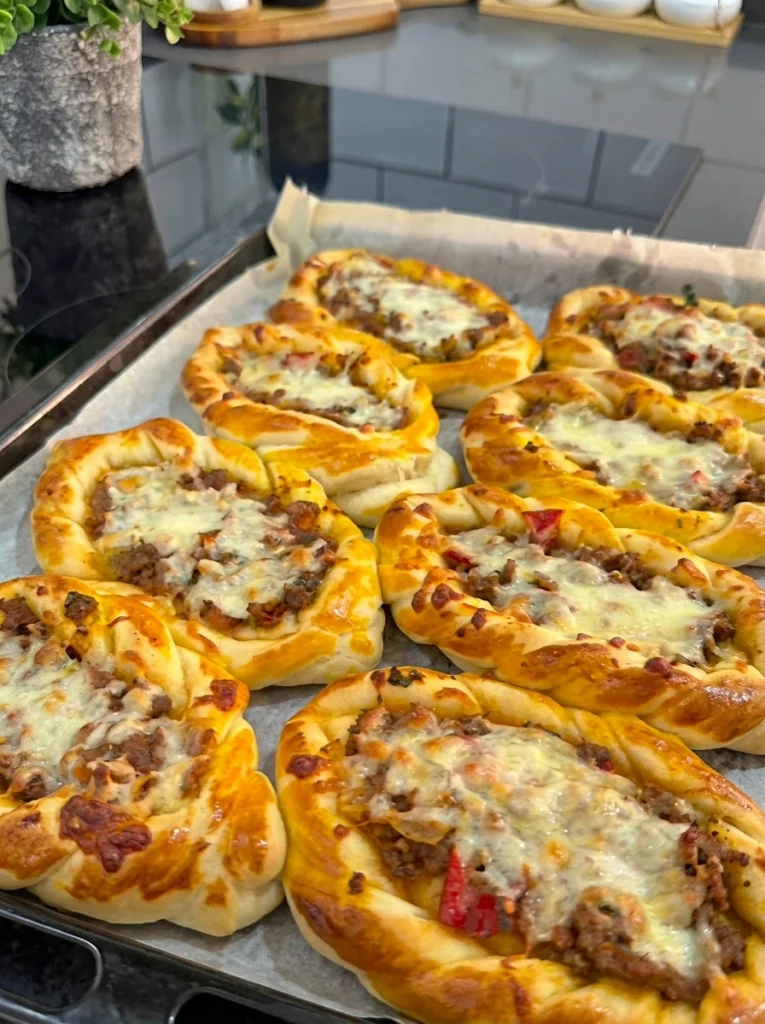 Prepared minced meat and kashar pide ready to bake in the oven.