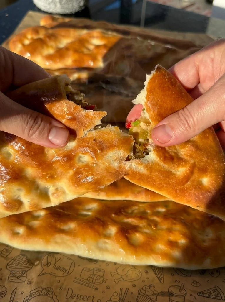 Freshly baked wild pides served with salad and yogurt sauce