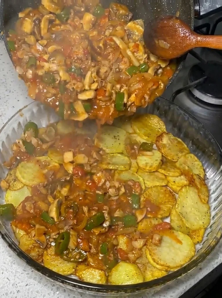Beef and mushroom skillet topped with cheddar cheese before baking