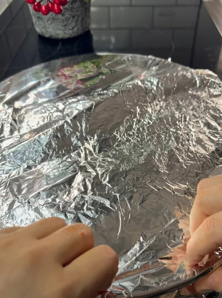 Belen Tava tray sealed with greased paper and aluminum foil