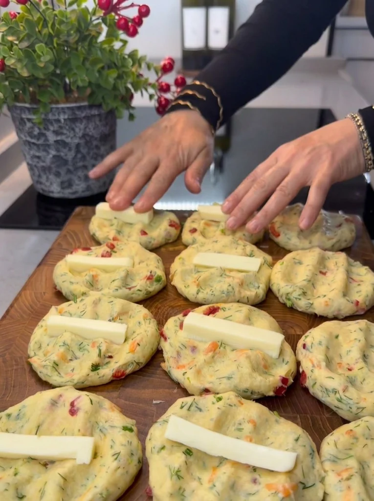 Shaping Biberli Derutelu Boğaça dough around cheese filling