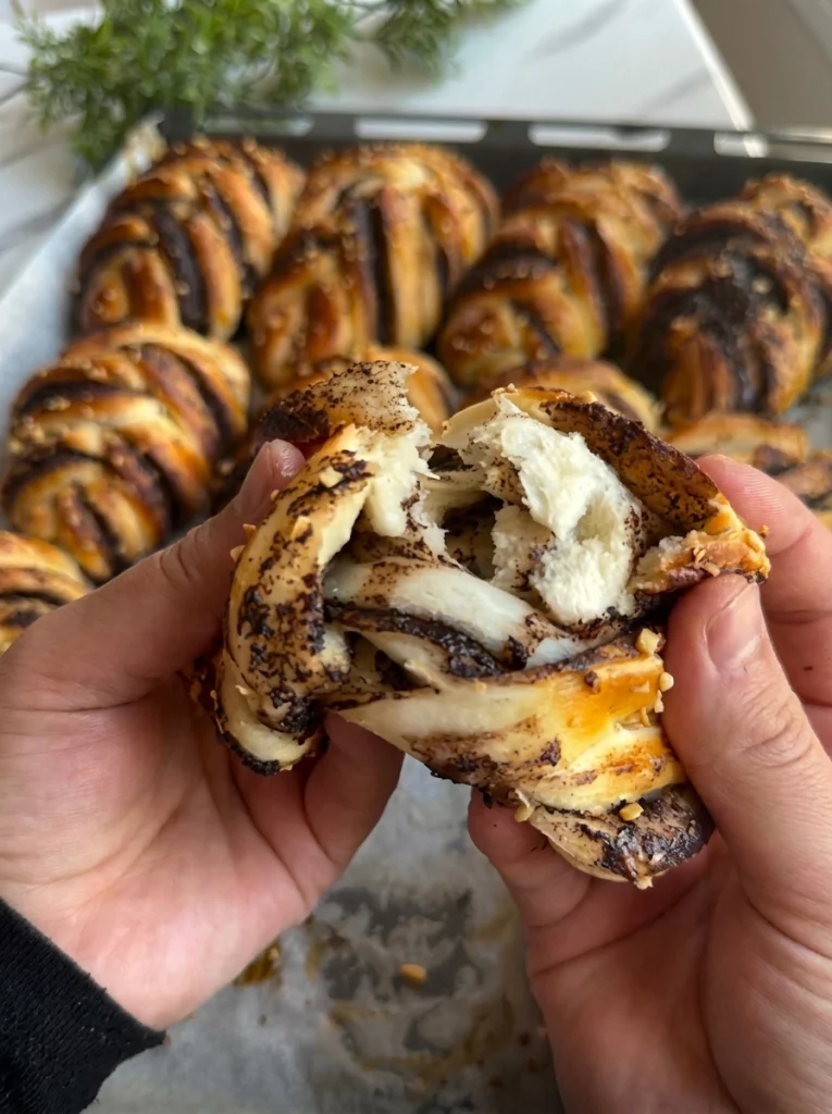Chocolate stuffed bun pulled apart showing melted chocolate