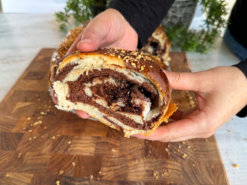 Sliced chocolate roll bread showing soft swirl layers