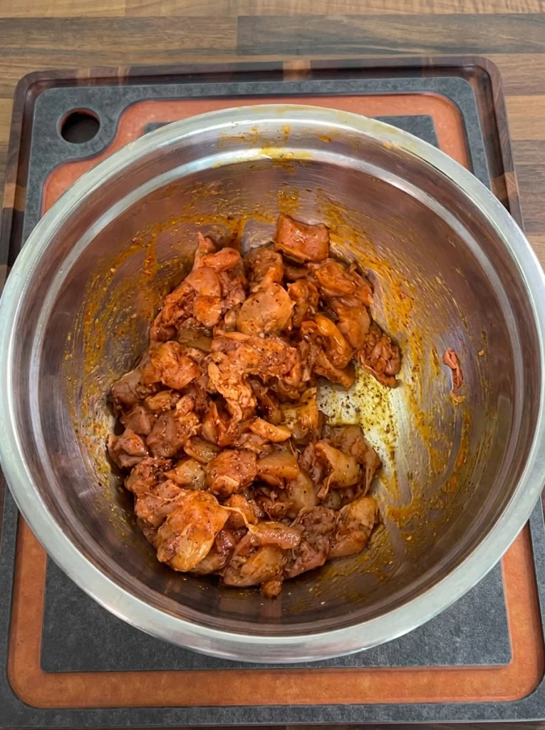 Chicken thighs coated in fajita seasoning before cooking