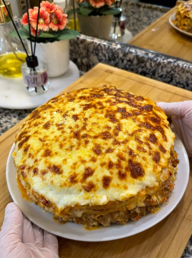 Close-up of crepe, meat filling, and béchamel layers in lasagna pancakes