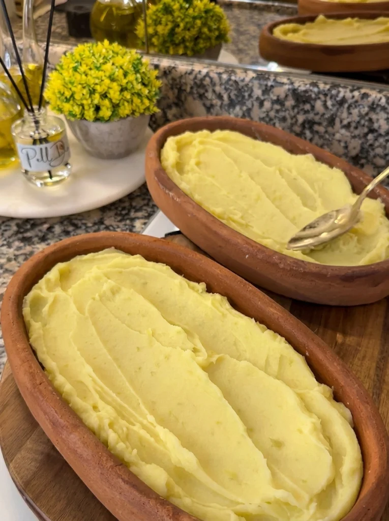 Creamy mashed potatoes spread in a casserole dish as the base layer