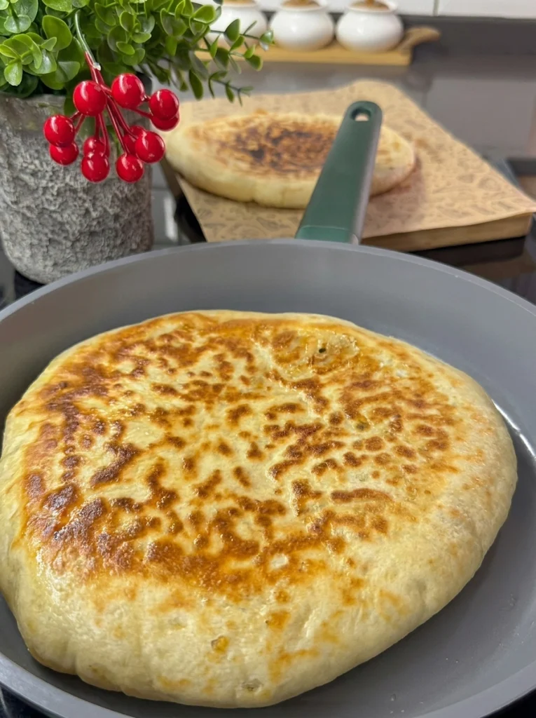 Moroccan stuffed potato flatbread served warm with mint tea