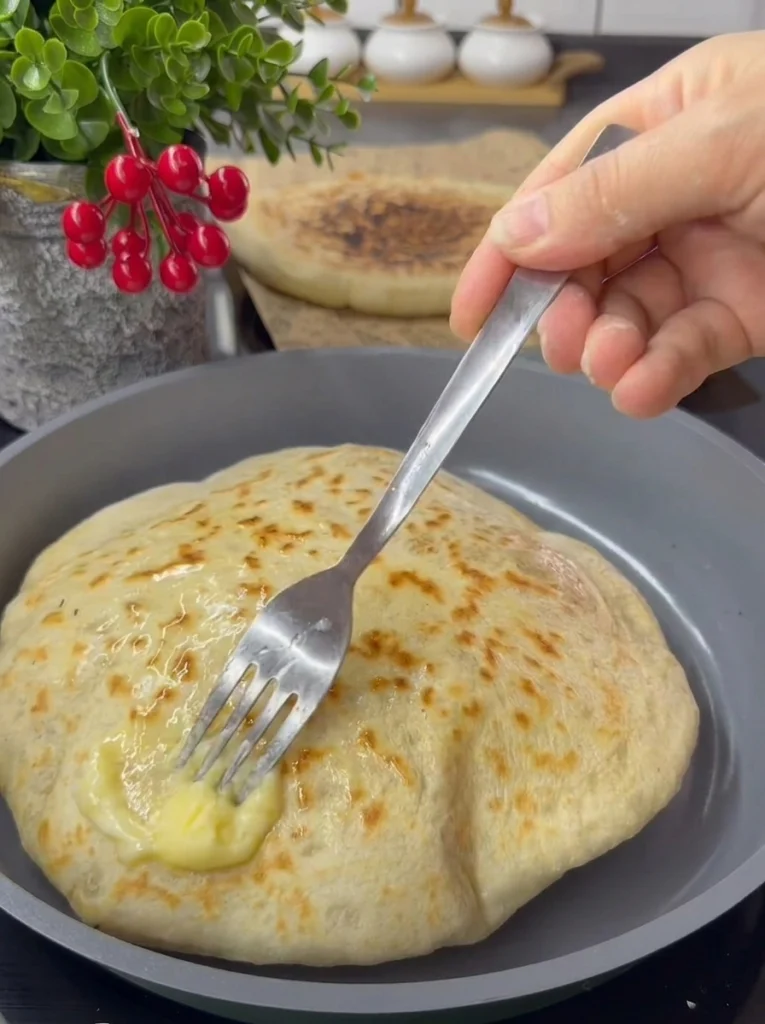 Close-up of crispy golden Moroccan flatbread with potato filling