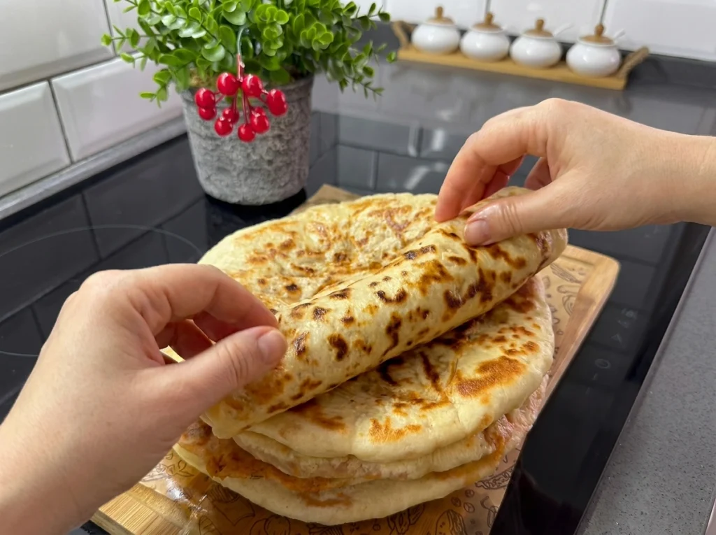 Golden Moroccan stuffed potato flatbread sliced open on a plate