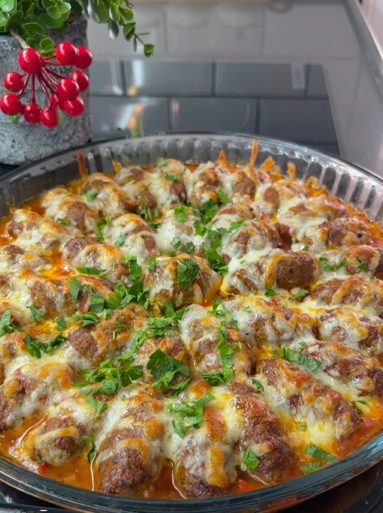 Close-up of oven-baked meatballs with vegetables served with bread