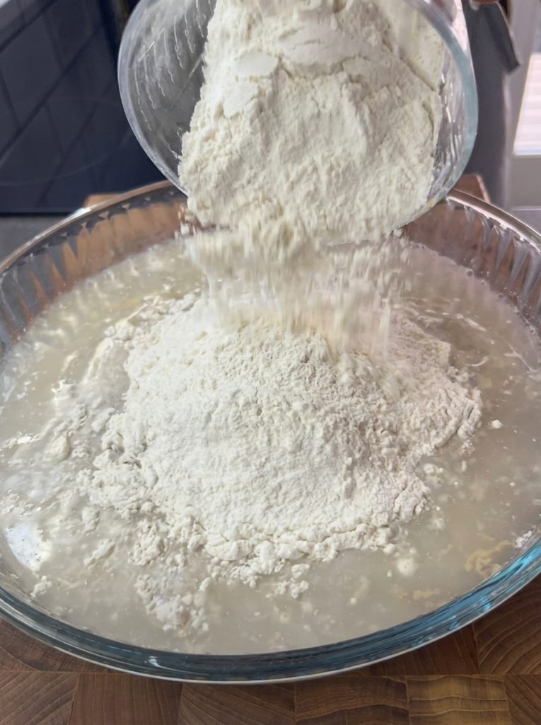 Sticky spoon bread dough being mixed in a bowl