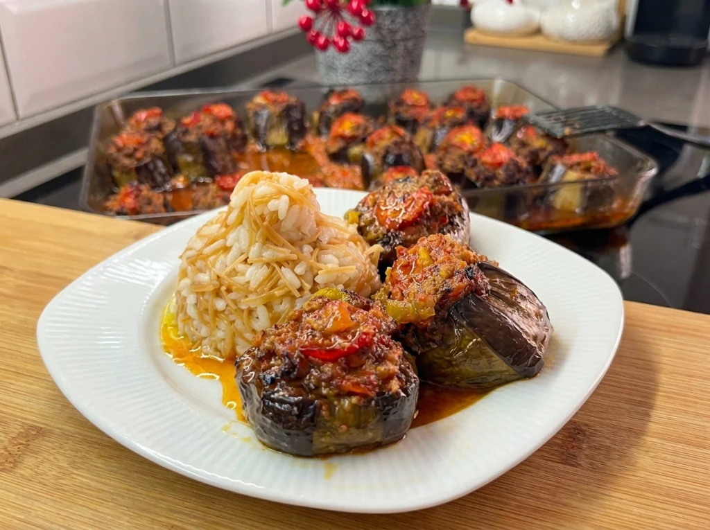 Stuffed eggplant recipe with minced meat filling on a baking tray