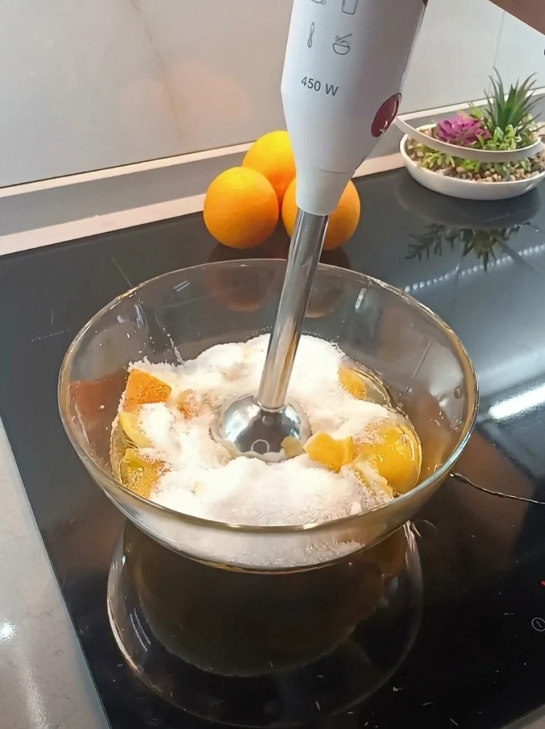 Ingredients for whole orange cake including orange, eggs, flour, and sugar